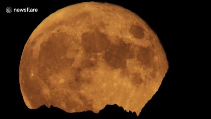 July's 'buck moon' rises over Dent Blanche mountain in Swiss Alps