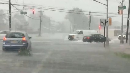 Cars plow through floodwaters as roads become rivers