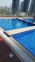 World tallest hotel swimming pool and view of Dubai downtown.