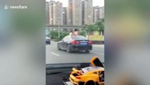 Twins spotted sitting on car roof as vehicle drives along busy road in China