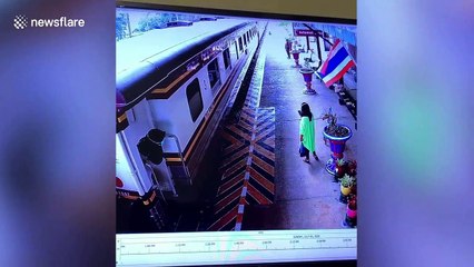 Thai woman playing on phone misses train then leaps into moving carriage