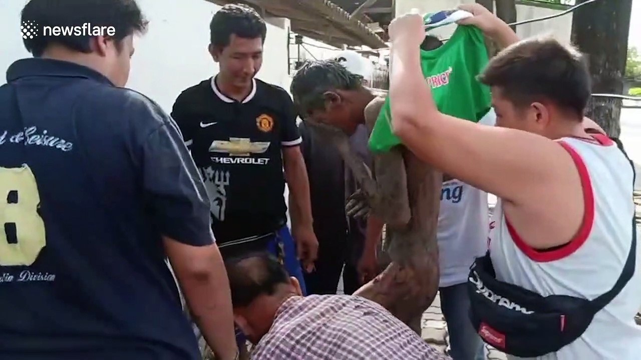 Alleged drunk man rescued after spending the night sleeping in muddy sewer in Thailand