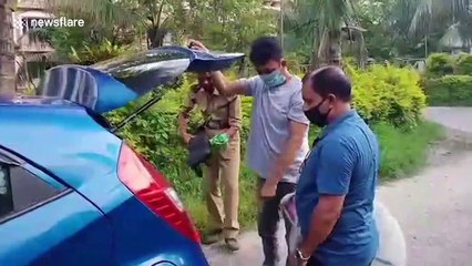 Large lizard rescued after getting stuck in university bathroom in India