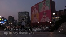 A corporate building in downtown Seoul lights up to thank medical workers and citizens