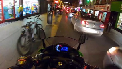 Angry boyfriend chases biker after revving at jaywalking girlfriend