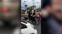 Wild monkey steals motorcycle passenger's food
