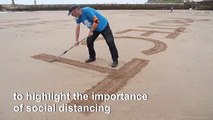 English sand artists create giant beach drawing to promote social distancing