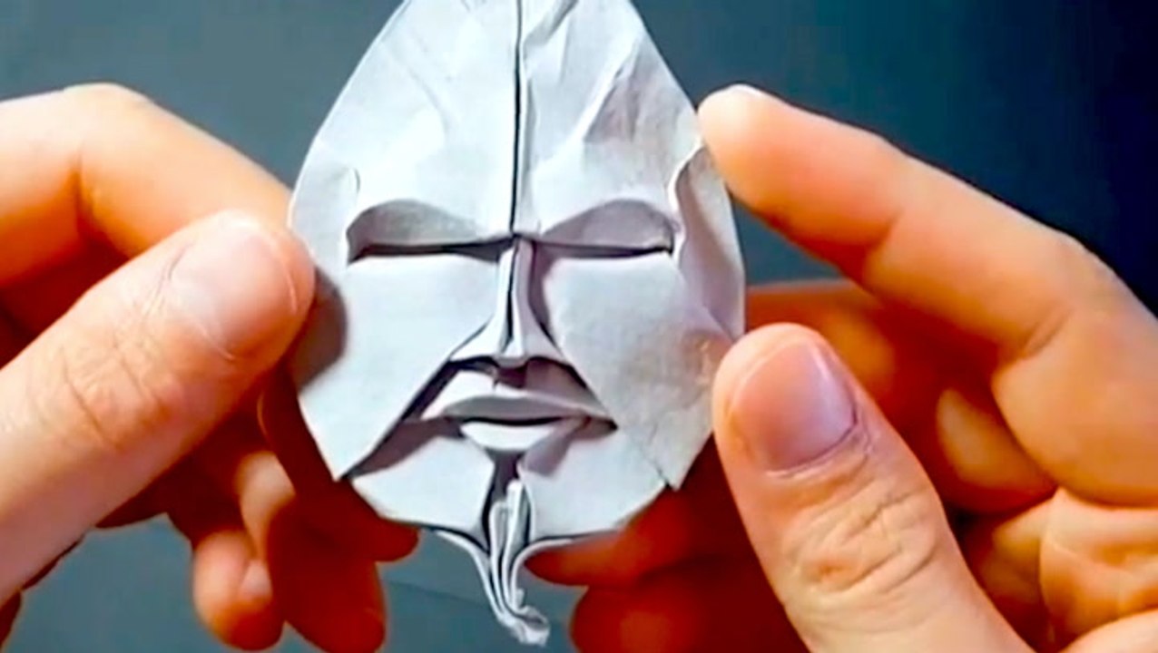 This artist folds intricate origami faces with paper