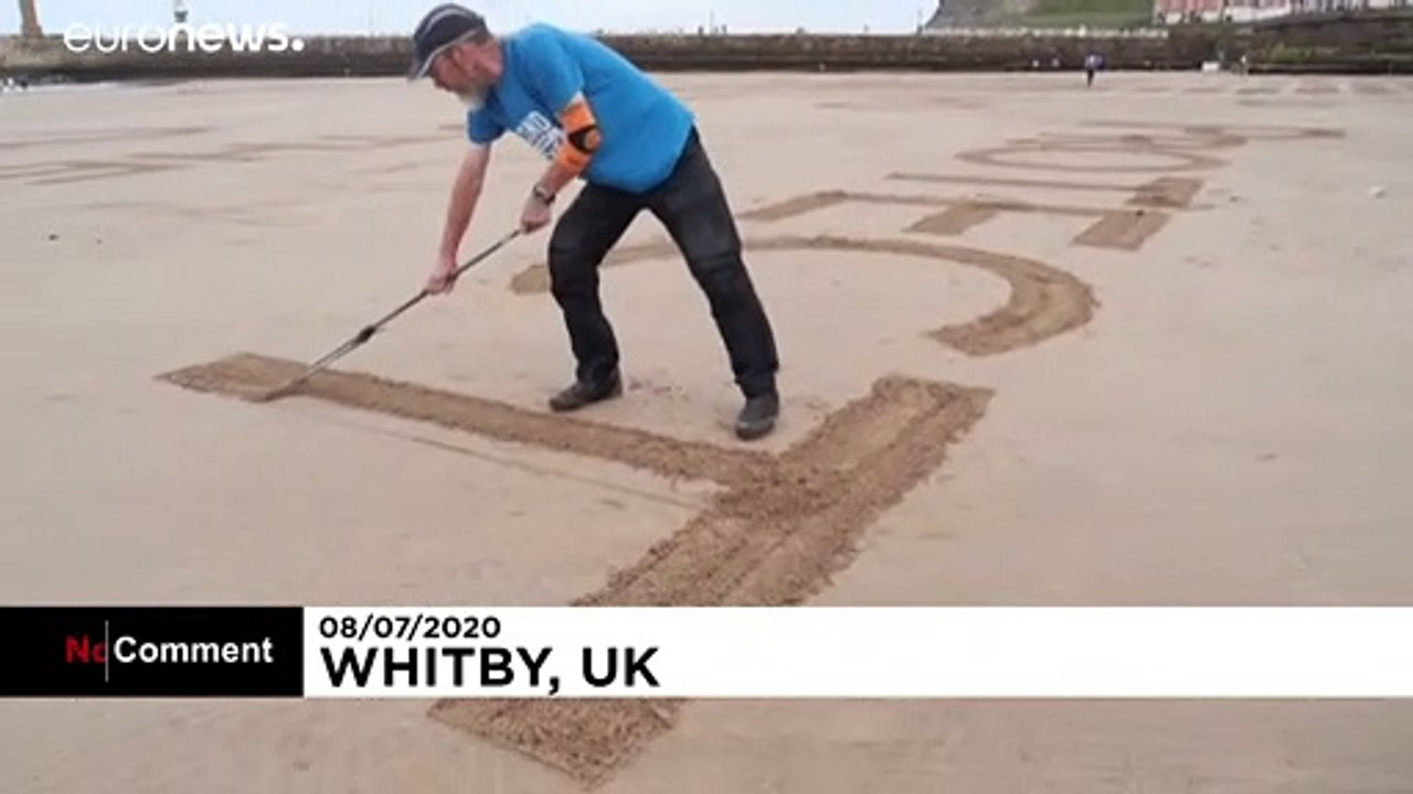 Dessins géants de sable contre le covid-19