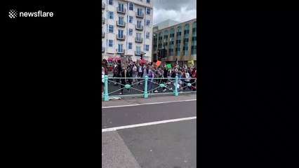 Hundreds of BLM supporters march through Brighton in masks while observing social distancing