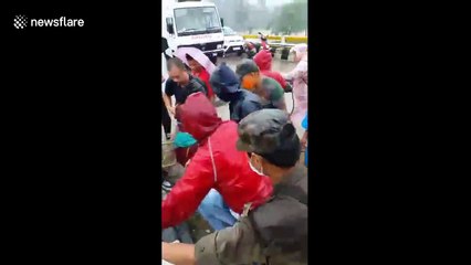 Indian rescuers haul stranded fishermen to safety from severe flooding