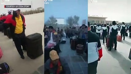 Uniformed Uyghurs wait to board trains