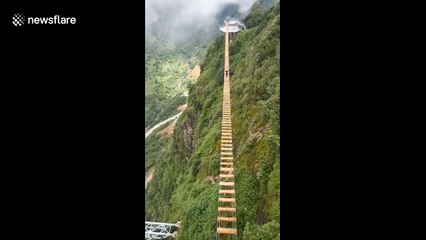 Adrenaline junkie takes on Vietnam's highest wooden suspension bridge