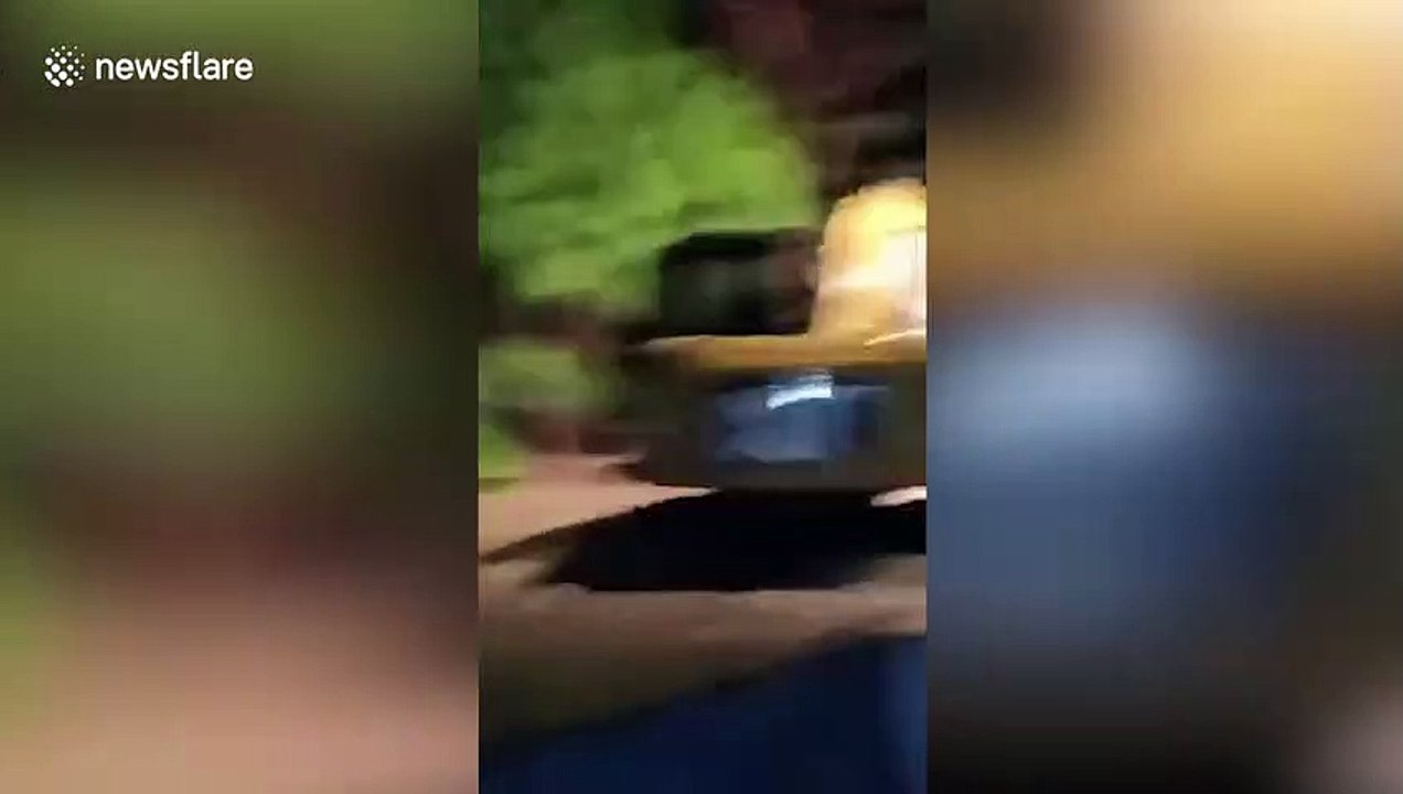 Stranded resident carried to safety in a digger as floods hit Indonesia