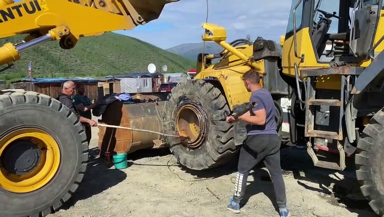 Guys Remove Bulldozer Tire