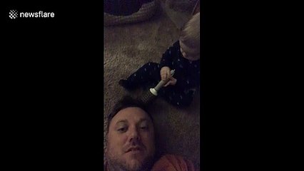 Baby boy with no chill smacks dad smack dab in the face with hairbrush