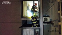Chinese firefighters save mother and son trapped on ledge during high-rise blaze