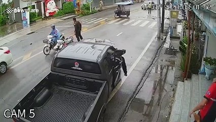 Driver survives after skidding on wet road being flung through door window