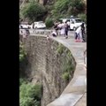 Reckless Father Puts Son’s Life At Risk — Dangles Him Over Mountain Road In China For Some Pictures