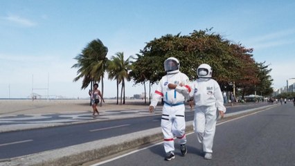 Brazilian couple wear spacesuits to the beach as protection against coronavirus