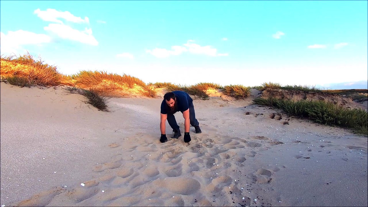 MMA ground and pound training Two handed hammer fists into the sand 3