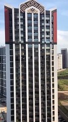 Woman Washes Window from Seventeenth Story