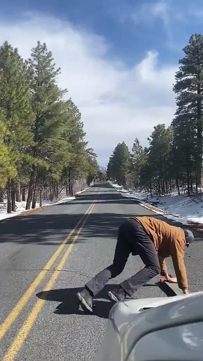 Man Handstands on Longboard down Grand Canyon Roadway