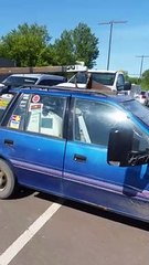 Small Modded Car Towing a Pop-Up Trailer and Boat