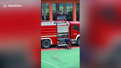 Excited fireman dances while putting extinguishers into fire engine in China