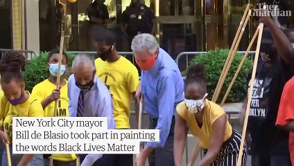 New York City mayor helps paint Black Lives Matter mural outside Trump Tower – video
