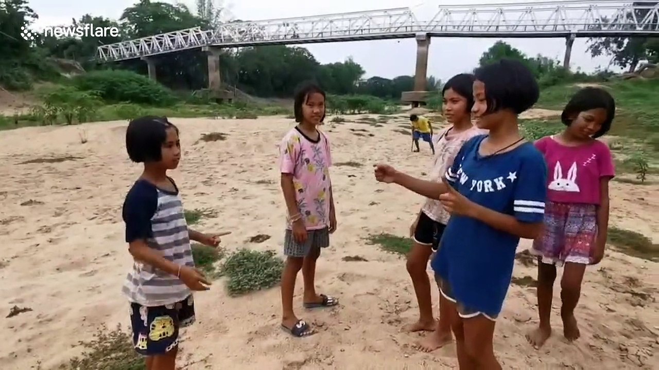 Kids use drought-hit river as football pitch in northern Thailand