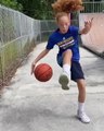 Girl Dribbles Two Basketballs While Hopping on Pogo Stick