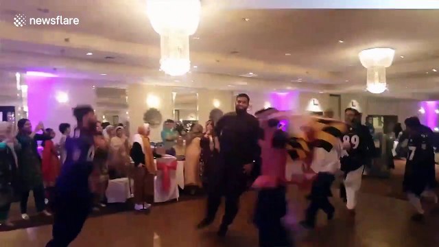 A throwback just in time for the NFL season: Bride and groom fuse Indian, Pakistani culture with Ravens-themed wedding entrance