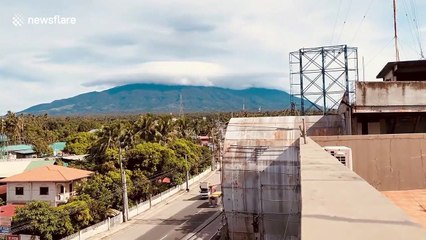 Breathtaking mass of white clouds flow over mountain in the Philippines