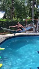 Woman Trying to Relax Flips in Poolside Hammock
