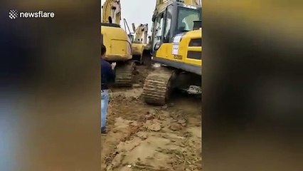 Chinese river embankment bursts and sweeps away excavators