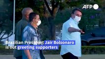 Bolsonaro greets supporters as he again tests positive for COVID-19