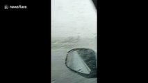 Man gets caught out driving his convertible BMW in rain storm