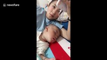 Baby boy bursts out with infectious laugh on queue in China