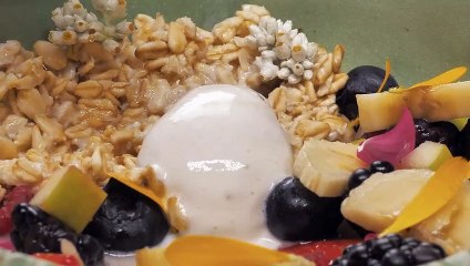 spoon-taking-a-mix-of-yougurt-with-seasonal-fruits