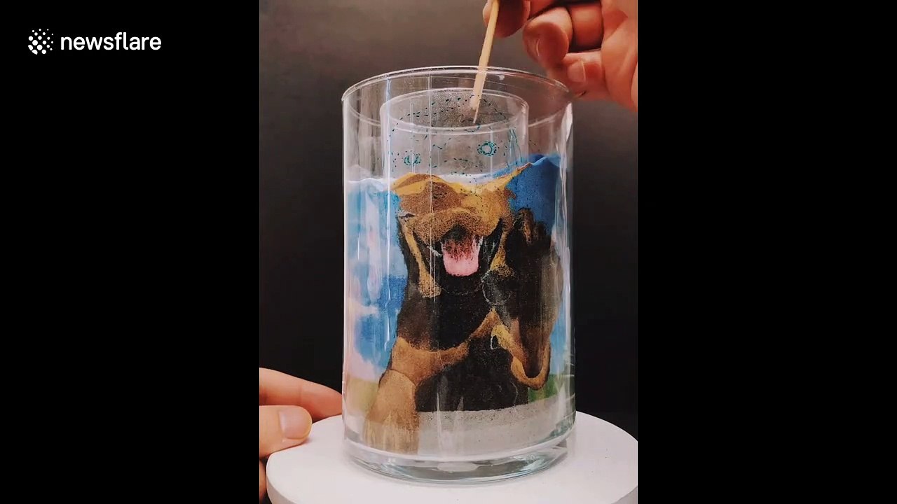 Sand artist creates cute portrait of puppy in cool timelapse