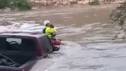 Two rescued as high water surrounds truck