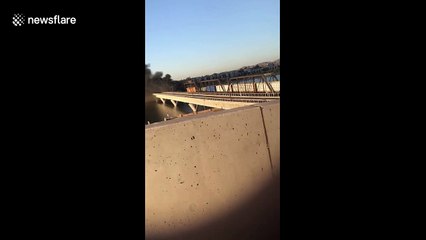 Locals watch smoke billow into sky after train derailment and bridge collapse in Tempe, Arizona