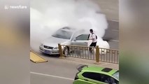Passersby remove ill driver from burning car after crashing into guardrails in China