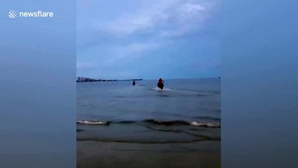 Three men on horseback ride into sea to save drowning boy in southern China