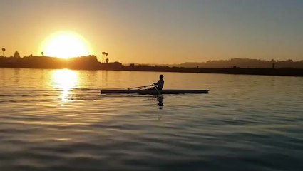 Early morning rowing in front of breathtaking sunrise