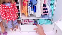 Sister dolls packing new travel suitcases with clothes for vacation trip