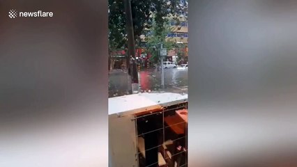 Woman swimming in floodwater narrowly avoids being hit by car in China