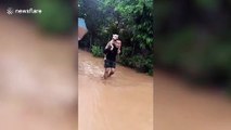 Hero soldier carries stray dog on shoulders as floods hit thousands of homes in Thailand