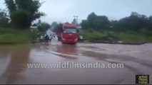 Bus drives onto flooded road and disappears into swirling waters!